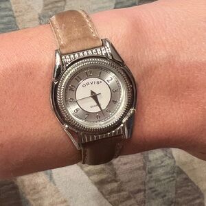 Orvis watch. Neutral color. Silver face. Still works. Good condition.